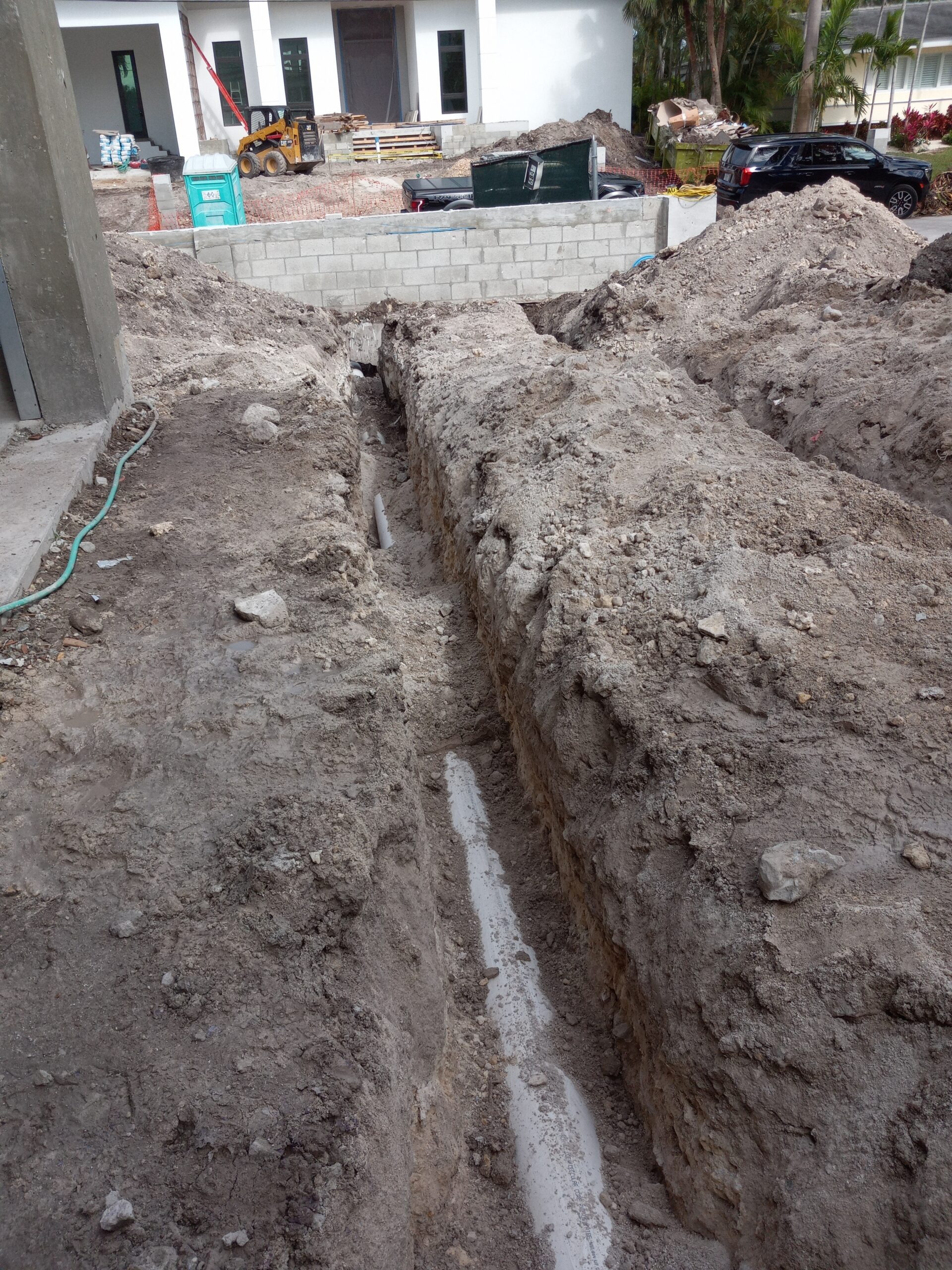 Deep construction trench with pipe.