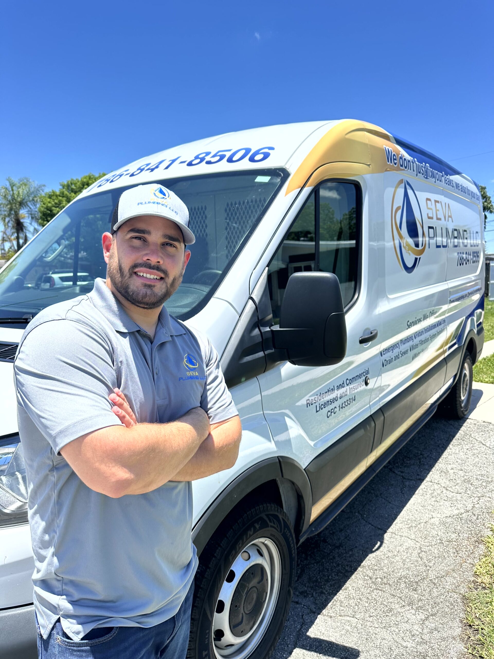 Plumber standing next to the service van