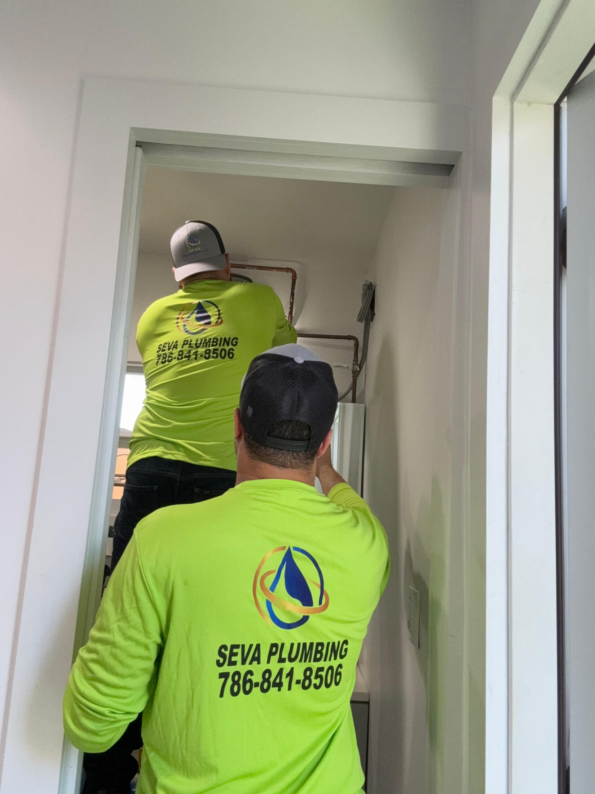 Two plumbing technicians fixing pipes