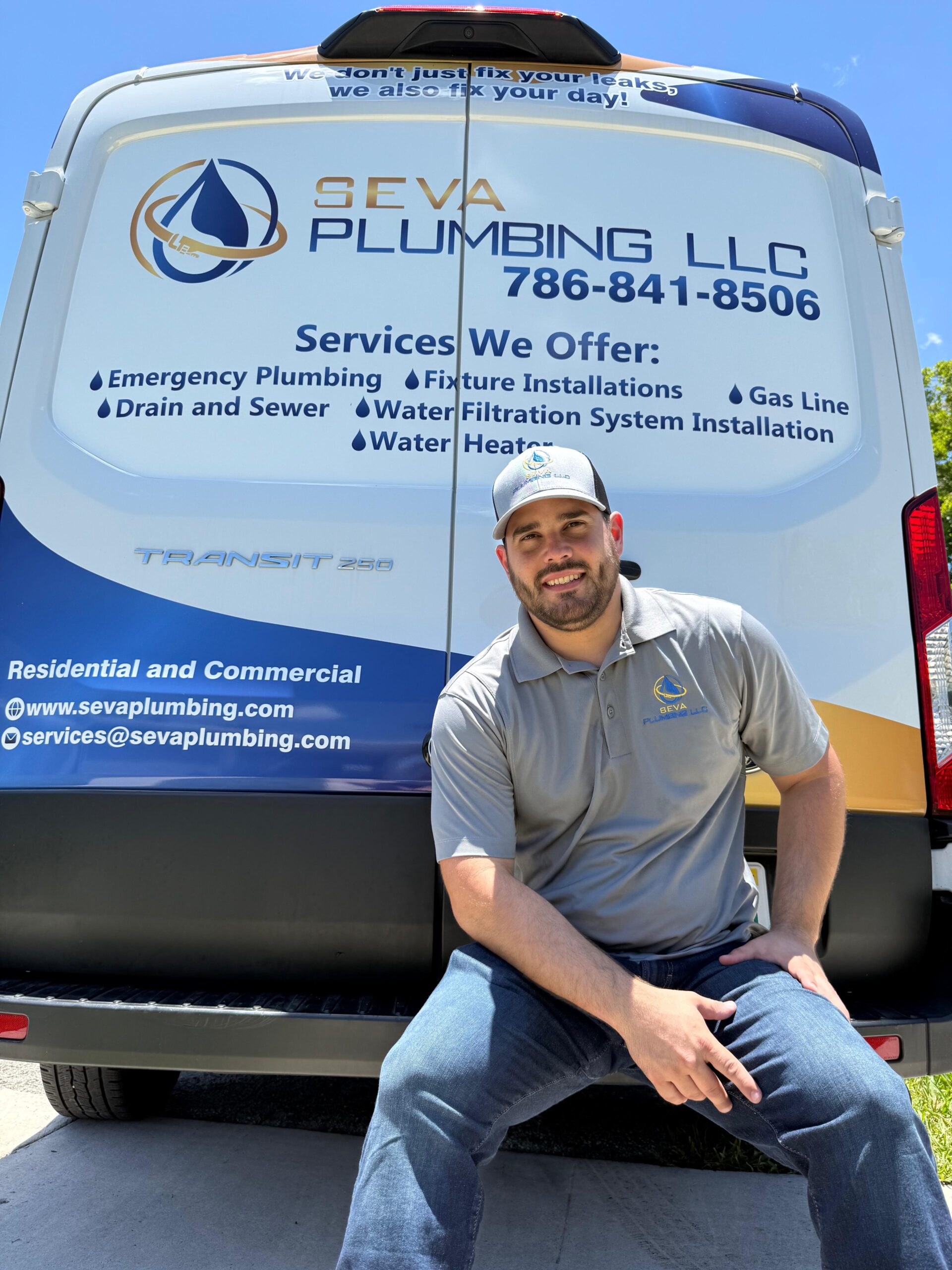 Smiling plumber on Seva Plumbing van job